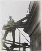 Akseli Gallen-Kallela at TarvaspÃ¤Ã¤Â´s tower working on a dragon-shaped gargoyle, 1927; photograph 1.