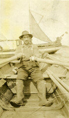 Hugh McInnis rowing in Sea Otter Cove
