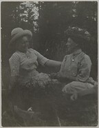 Olga SlÃ¶Ã¶r and Mary Gallen-Kallela sitting on a field; print 1 of the photograph.