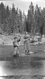 Woman and boy fishing in a river