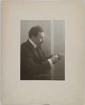 Axel GallÃ©n, wearing a suit, carving wood, in Vienna, ca.1907; photograph with a frame.