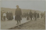 A postcard depicting people standing on a pier by OulujÃ¤rvi lake