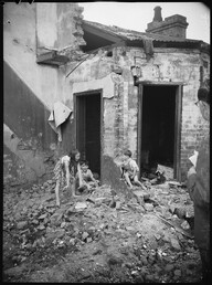 Children playing in demolished houses, urban renewal, Surry Hills, photographed by Harry Freeman