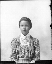 Portrait photograph of girl in gingham dress n.d.
