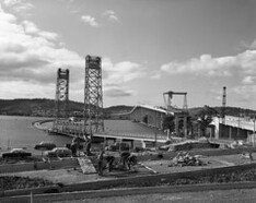View of Tasman Bridge under construction with Hobart pontoon bridge still in place (1964)