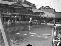 Miss J Thompson on the diving board, ca. 1930 / photographer Sam Hood