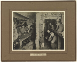 "Safe from the shells" - soldiers playing cards in dug-out shelter, undated
