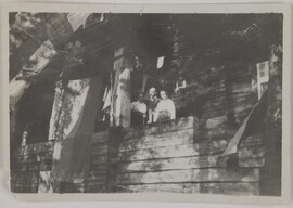 Mary and Akseli Gallen-Kallela and a third person on the balcony decorated with flags at Kalela, in Ruovesi, ca. 1920.