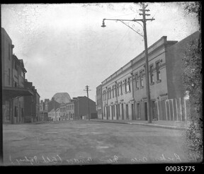 Gloucester Street in The Rocks with Sydney Harbour Bridge in background, c 1933