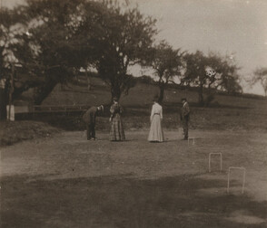 [Photograph depicting men and women playing croquet]