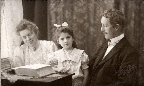 Portrait of a family seated by the window