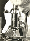 A man with a Reichert microscope