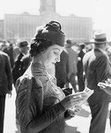 Woman reading the race guide, Sydney Cup, Randwick Racecourse, March 1937, by Sam Hood