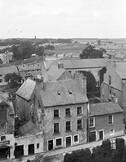 Elevated view of buildings in a town, one of the buildings has the sign "Thomas Hart, Marine dealer"