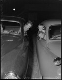 Children looking out of car windows, open air films, Bondi Beach, Sydney, 29 December 1951