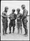 Lionel van Praag (far left), manager of the Sydney Speedway talking with cyclists, Speedway series, 9 February 1946