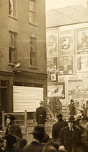 "Street scene with advertising hoardings" but where? Corner of Summerhill and Langrishe Place!