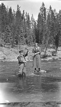 Woman and boy fishing in a river