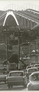 Traffic and line of telegraph poles approach the Gladesville Bridge, Oct 1966