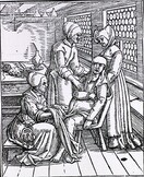 Three midwives attending to a pregnant woman