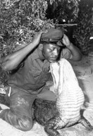 African American man wrestling an alligator at the St. Augustine Alligator Farm