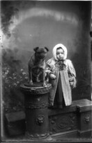 Portrait photograph of toddler with dog n.d.