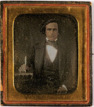 Daguerreotype. Portrait of a man with a book and pen.