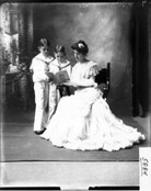 Mrs. Harvey Cook reading with two boys 1904