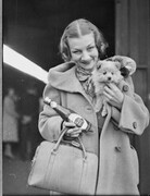 Ballet star Helene Kirsova with puppy and tomato sauce bottle on arrival back in Sydney for a return season, Central Railway Station, May 1937 / Sam Hood