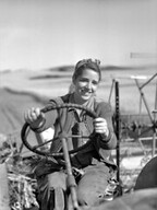 Woman driving a combine harvester