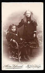 Portrait of two girls in similar dresses