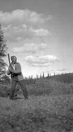 Charles Lee at bat with a canine catcher