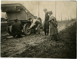 Changing a tire on a muddy Hamilton road