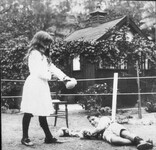 Banjo Paterson's children Grace and Hugh boxing with Christmas present gloves, Sydney, NSW, 1919 / photographer unknown