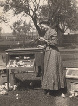 Woman holding baby chick, 1910