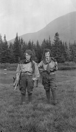 Two women on a trek with rifles and cartridge belts