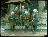 Rural women in local attire carrying large baskets on their backs.