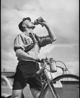 Rider carrying spare inner tubes, 'Thousand Mile Cycle Race', New South Wales, 10 October 1945, Alec Iverson