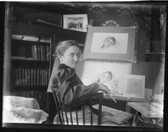 Young woman at easel with painting n.d.
