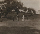 [Photograph depicting men and women playing croquet]