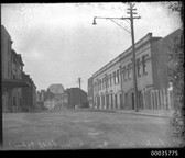 Gloucester Street in The Rocks with Sydney Harbour Bridge in background, c 1933