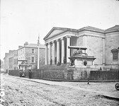 "Large public building, railings, steps, 6 columns in portico, 2 guns on plinths, one plinth inscribed India" is Tralee Courthouse
