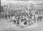 Children doing physical education exercises in school yard of Central School, Bathurst Street, Tasmania (c1900s)