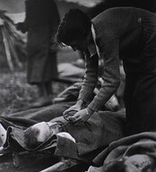 U.S. Army Evacuation Hospital Nos. 6 & 7, Souilly, France, Red Cross worker Miss Anna Rochester, of the Smith College Unit, feeding wounded soldier through a tube