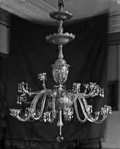 The Crystal chandeliers light up the paintings on the wall