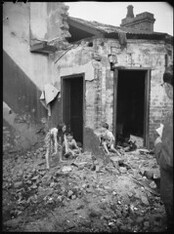 Children playing in demolished houses, urban renewal, Surry Hills, photographed by Harry Freeman