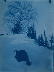Cyanotype picturing a snow-covered hillside and fence