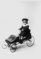 Child driving a toy car