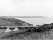 â€œView of a coastline, dotted with tents and houses, in an unknown locationâ€ = Church Bay, Co. Cork looking across at Roches Point lighthouse