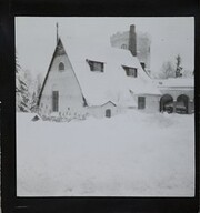 Winter-time view of TarvaspÃ¤Ã¤, photographed from the south-west. The picture features the building's roofs and its characteristic central tower and entrance archway